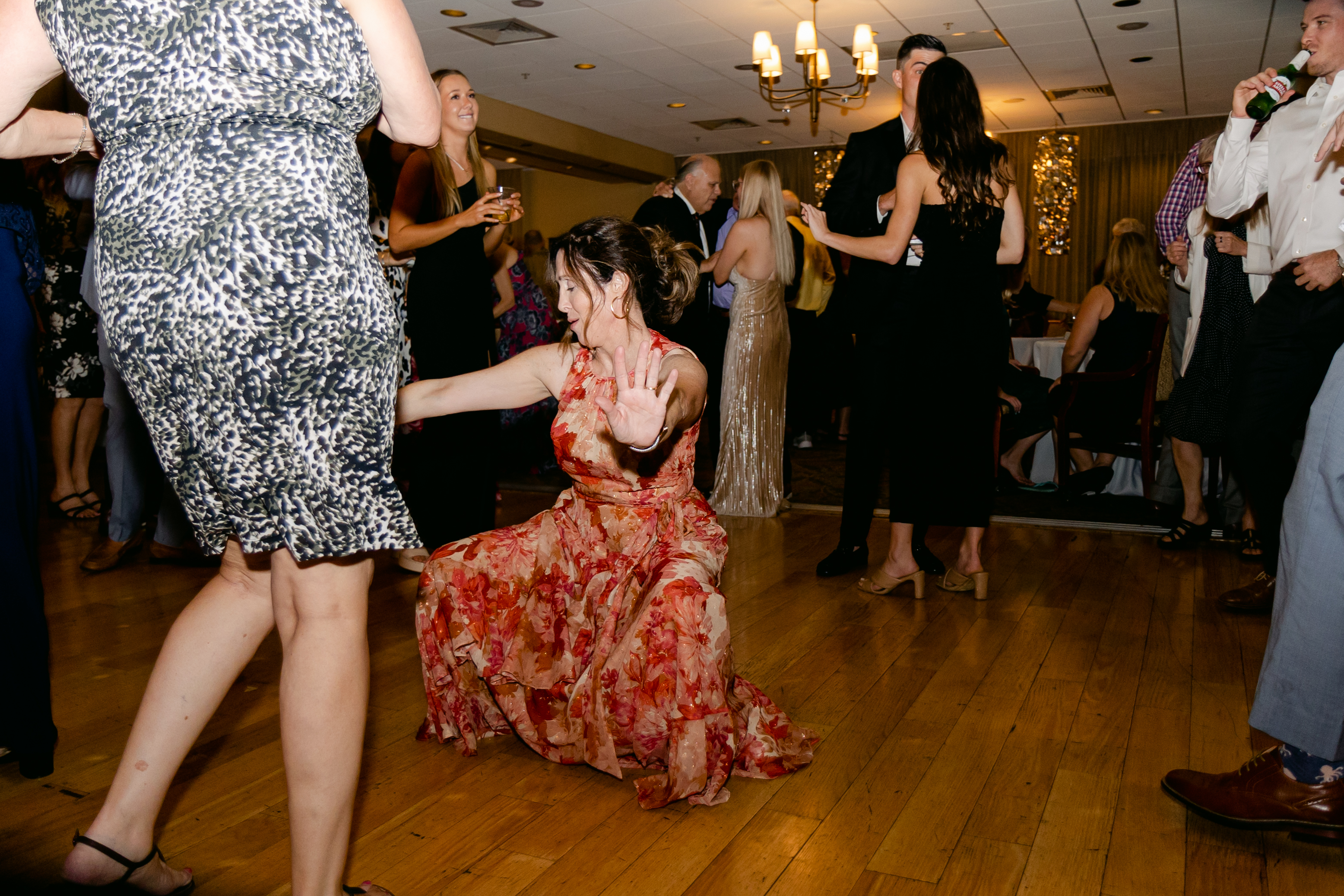 Wedding party kneeling in a hype circle on the dance floor