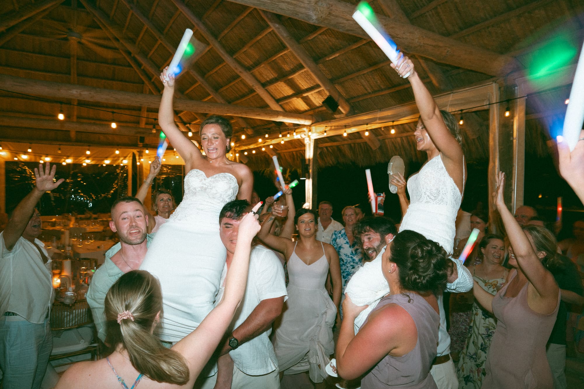 Sunset destination wedding reception lit by string lights