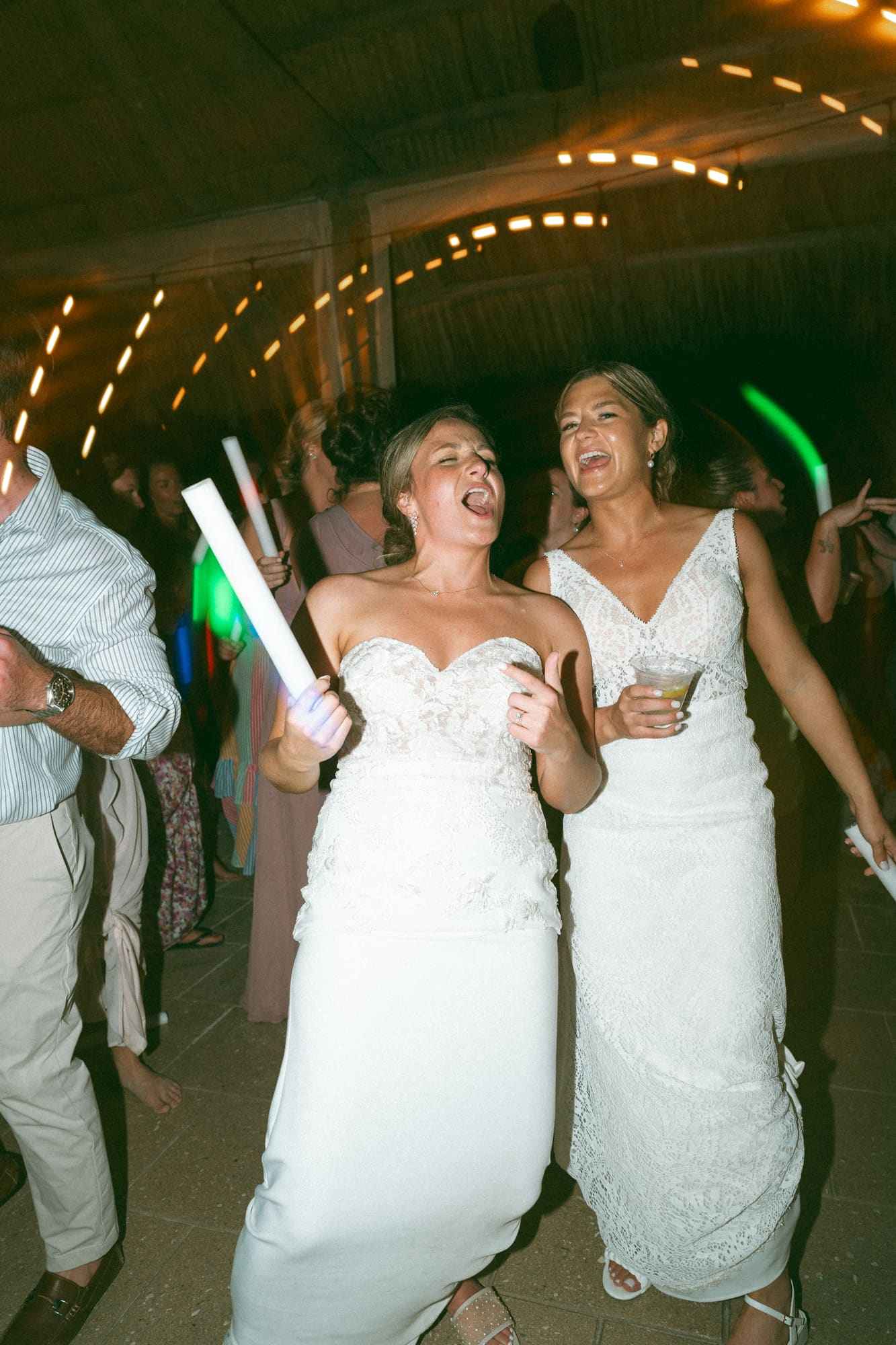Brides on the microphone at a Modern Era Weddings reception