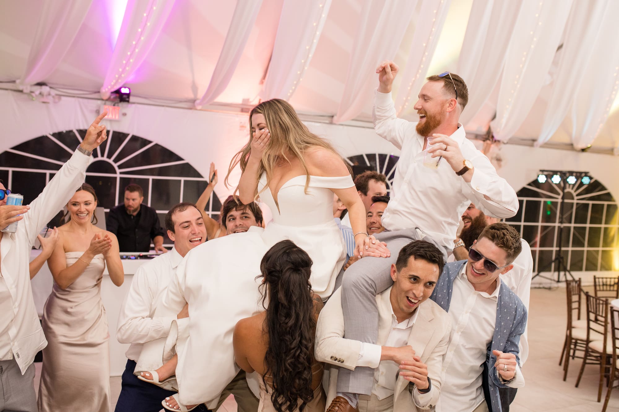 Bride lifted with groomsman on the dance floor